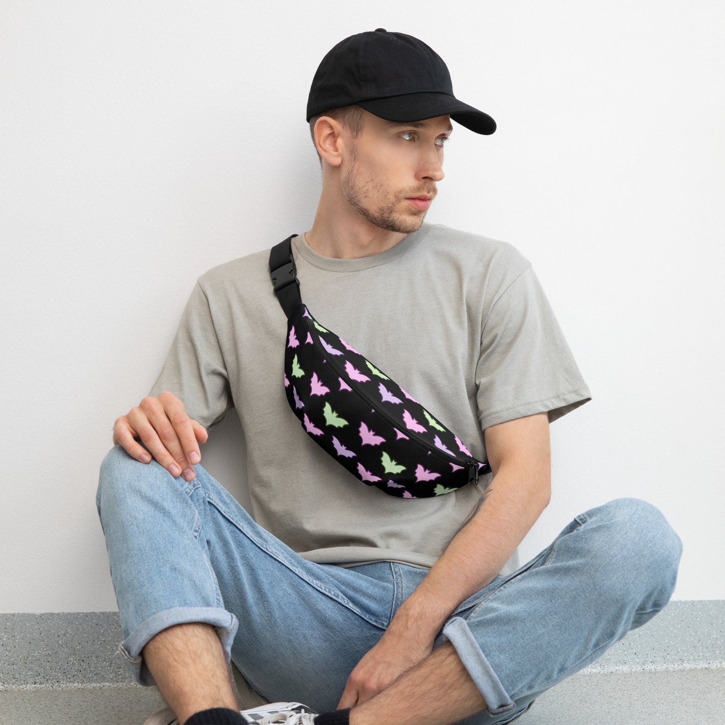 Man wearing a baseball hat wearing Neon Bat Fanny Pack across his chest