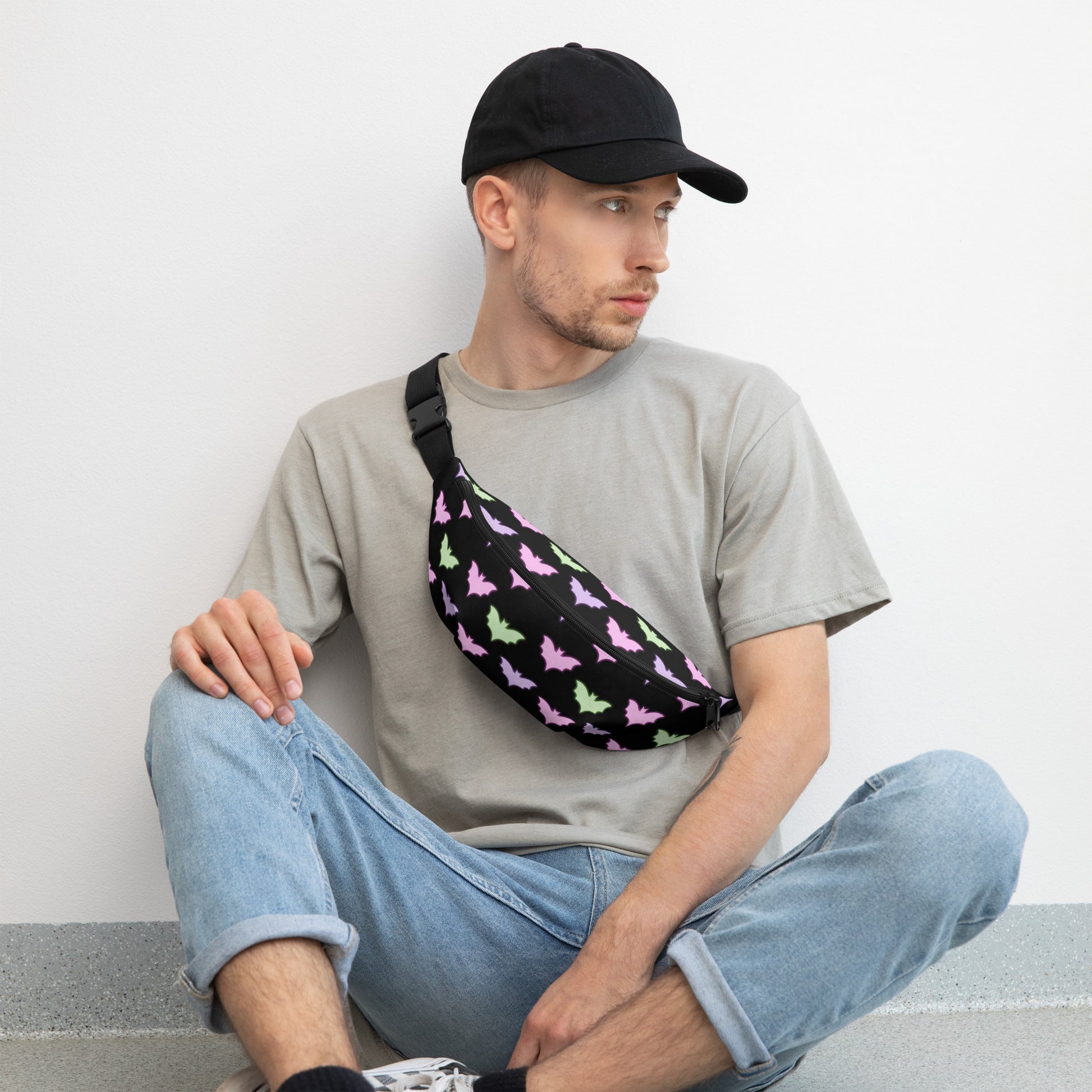 Man wearing a baseball hat wearing Neon Bat Fanny Pack across his chest